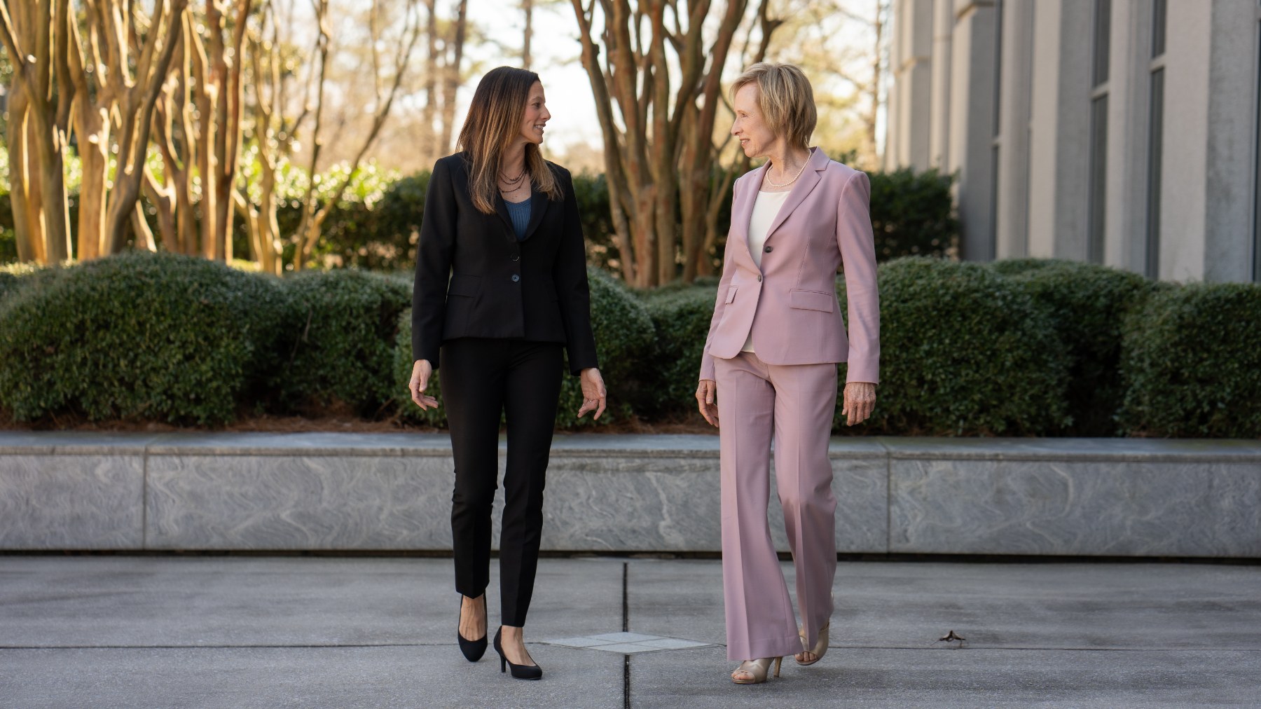 Two professionals walking and talking outside